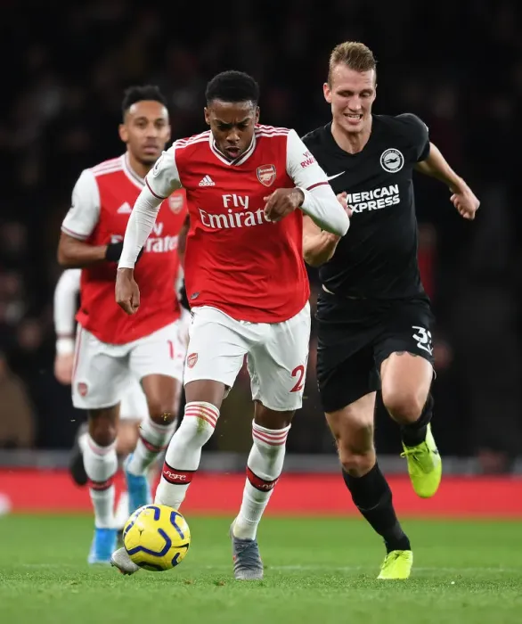 Framed Print : Arsenal's Joe Willock Outmaneuvers Brighton's Dan Burn in Premier League Clash