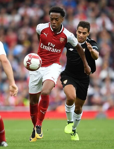 Arsenal's Joe Willock Outmaneuvers Sevilla's Wissam Ben Yedder during the Emirates Cup Clash