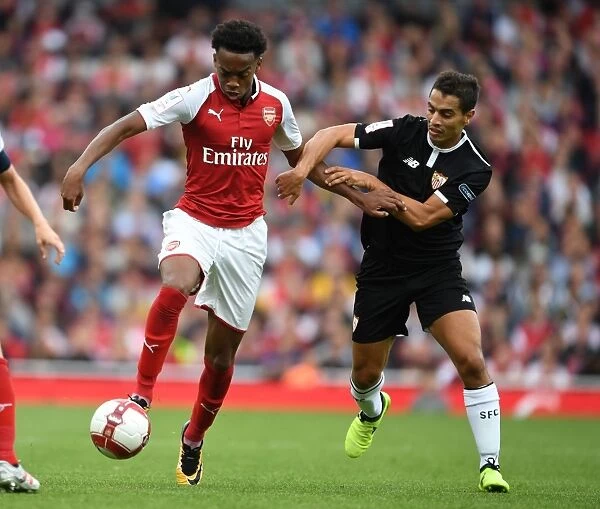 Arsenal's Joe Willock Tackles Sevilla's Wissam Ben Yedder in Emirates Cup Clash