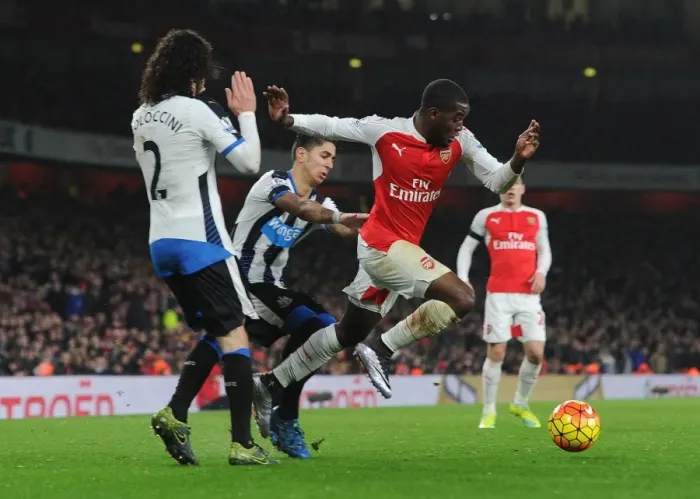 Framed Print : Arsenal's Joel Campbell Faces Off Against Newcastle's Coloccini and Perez During Intense Premier League Clash Framed Print : Arsenal's Joel Campbell Faces Off Against Newcastle's Coloccini and Perez During Intense Premier League Clash