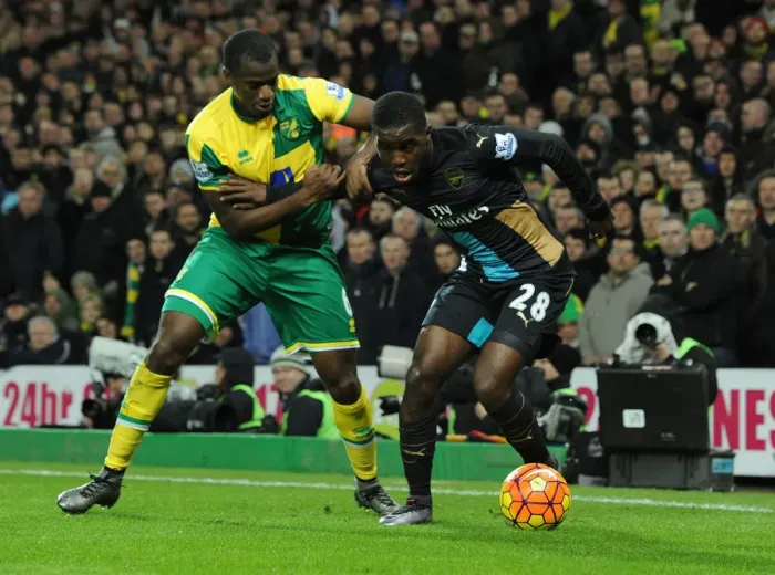 Framed Print : Arsenal's Joel Campbell Fends Off Norwich Defender During Intense Premier League Showdown