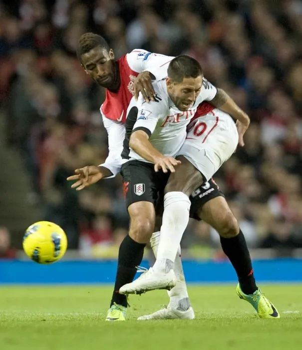 Framed Print : Arsenal's Johan Djourou Faces Off Against Fulham's Clint Dempsey in Premier League Clash Framed Print : Arsenal's Johan Djourou Faces Off Against Fulham's Clint Dempsey in Premier League Clash