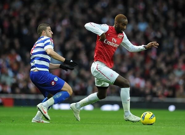 Arsenal's Johan Djourou Outmaneuvers QPR's Adel Taarabt during Premier League Clash