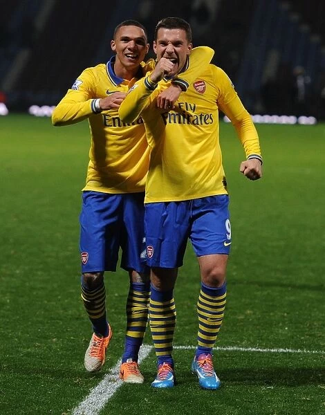 Arsenal's Jubilant Duo: Podolski and Gibbs Celebrate Victory over West Ham United