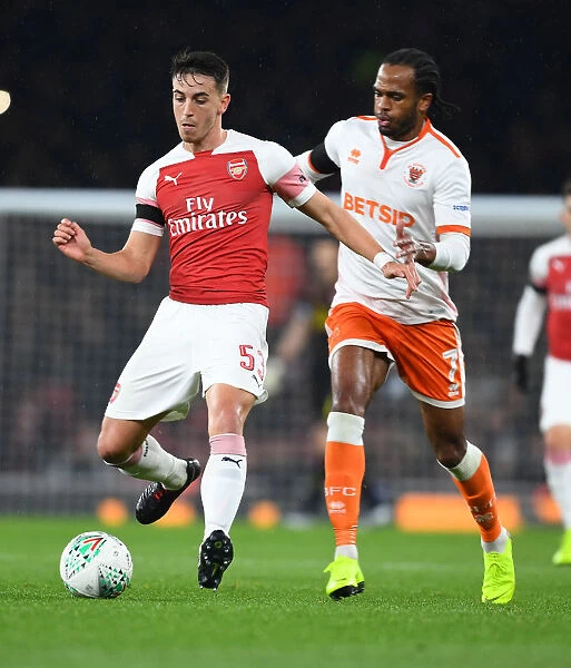 Arsenal's Julio Pleguezuelo Clashes with Blackpool's Nathan Delfouneso in Carabao Cup Showdown