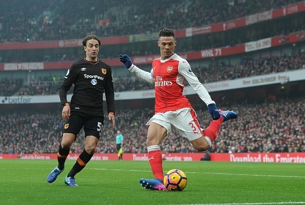 Arsenal's Kieran Gibbs Battles Lazar Markovic of Hull City in Premier League Clash at Emirates Stadium