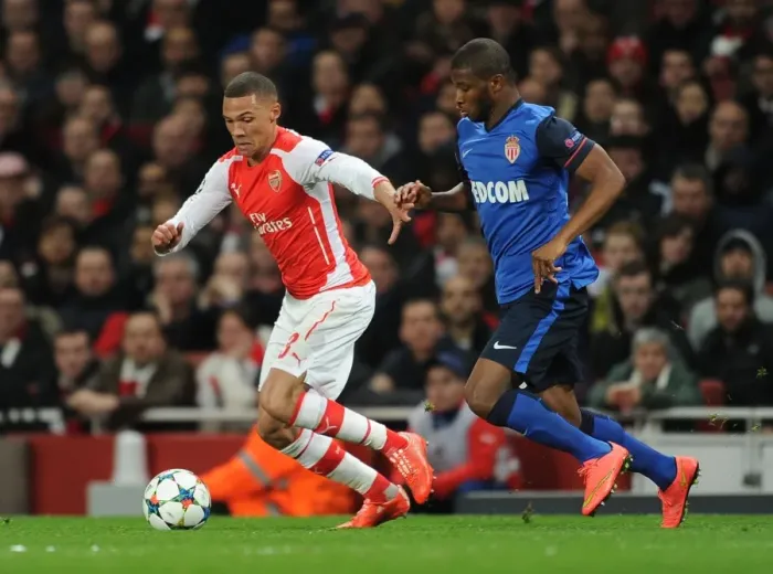 Framed Print : Arsenal's Kieran Gibbs Clashes with Monaco's Elderson in Champions League Showdown