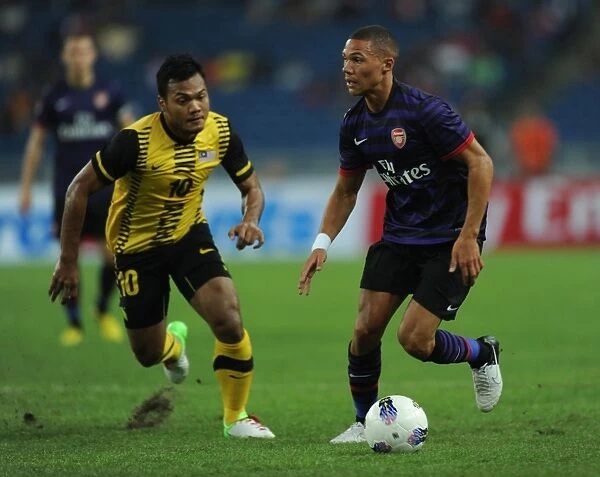 Arsenal's Kieran Gibbs Faces Off Against Mohd Sali of Malaysia XI During Pre-Season Friendly