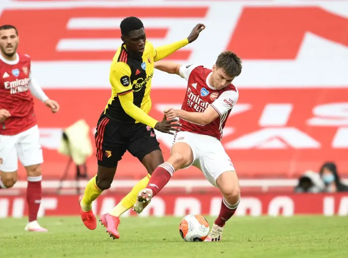 Framed Print : Arsenal's Kieran Tierney Clashes with Watford's Ismaila Sarr in Premier League Showdown Framed Print : Arsenal's Kieran Tierney Clashes with Watford's Ismaila Sarr in Premier League Showdown