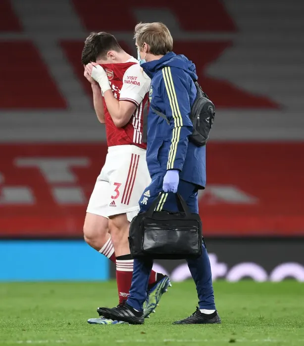 Framed Print : Arsenal's Kieran Tierney Exits with Injury as Arsenal v Liverpool Plays Behind Closed Doors (2020-21)