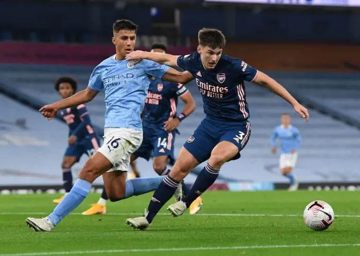 Framed Print : Arsenal's Kieran Tierney Faces Off Against Manchester City's Rodrigo in Premier League Clash