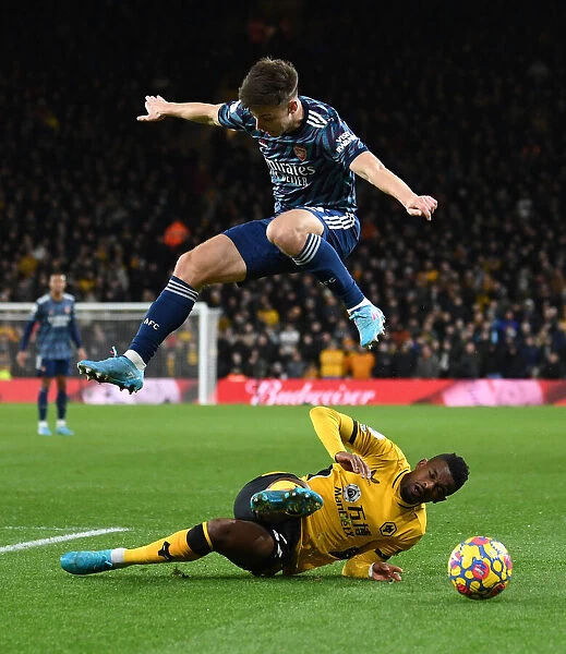 Arsenal's Kieran Tierney Leaps Over Wolves Francisco Trincao in Premier League Clash