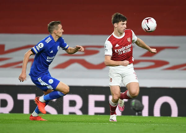 Arsenal's Kieran Tierney Outmaneuvers Leicester City's Timothy Castagne in Empty Emirates Stadium