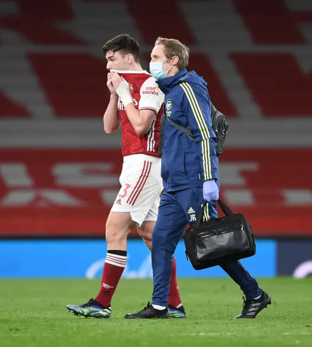 Framed Print : Arsenal's Kieran Tierney Suffers Injury and Exits Field During Arsenal vs Liverpool (2021)
