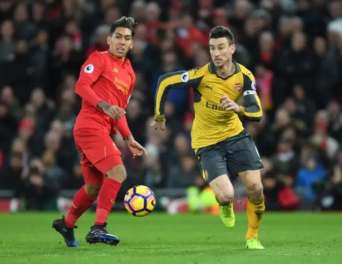Framed Print : Arsenal's Koscielny Battles Past Firmino in Intense Liverpool vs. Arsenal Clash (Premier League 2016-17) Framed Print : Arsenal's Koscielny Battles Past Firmino in Intense Liverpool vs. Arsenal Clash (Premier League 2016-17)
