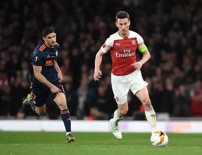 Framed Print : Arsenal's Koscielny Battles Past Valencia's Guedes in UEFA Europa League Semi-Final Showdown Framed Print : Arsenal's Koscielny Battles Past Valencia's Guedes in UEFA Europa League Semi-Final Showdown