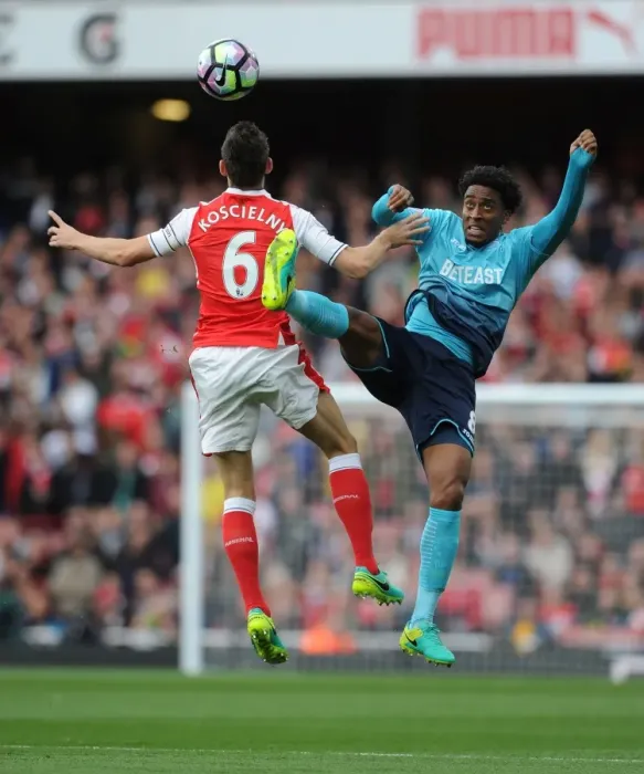 Framed Print : Arsenal's Koscielny Clashes with Swansea's Fer: A Premier League Showdown
