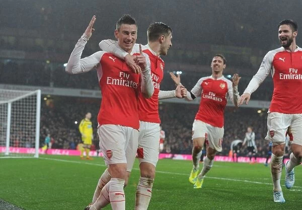 Arsenal's Koscielny, Ramsey, and Giroud: Triumphant Trio Celebrates Goal Against Newcastle United (2015-16)