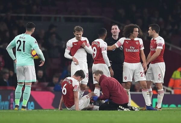 Arsenal's Koscielny Receives Treatment from Physio Jordan Reece during Arsenal v Bournemouth Match