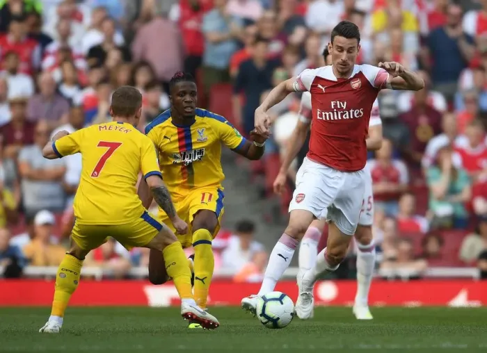 Framed Print : Arsenal's Koscielny vs Zaha: A Premier League Face-Off at Emirates Stadium