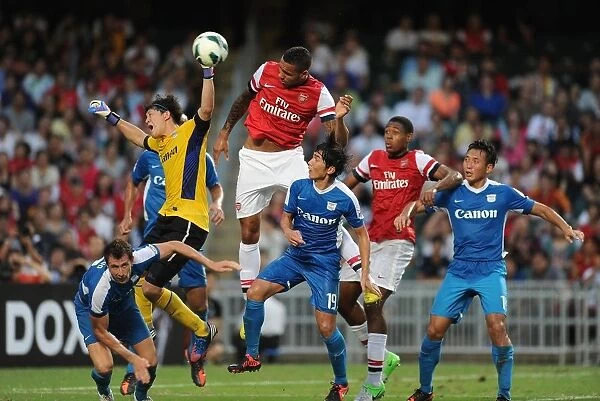 Arsenal's Kyle Bartley Leaps Over Kitchee Goalkeeper During Pre-Season Clash