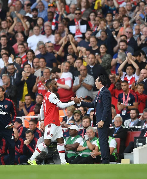 Arsenal's Lacazette Bids Farewell to Emery on the Field during Arsenal vs. Tottenham Match, 2019-20 Premier League