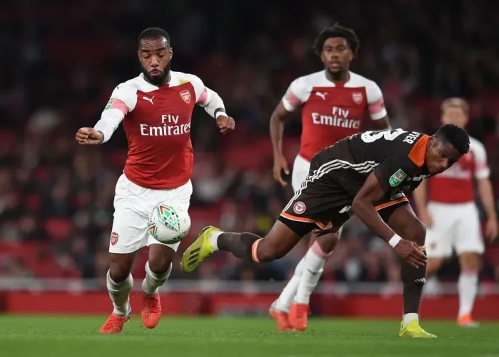 Framed Print : Arsenal's Lacazette Clashes with Brentford's Jeanvier in Carabao Cup Showdown