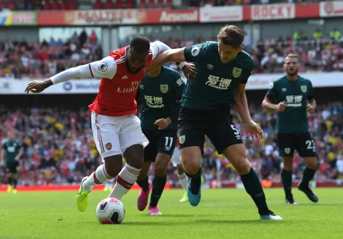 Framed Print : Arsenal's Lacazette Clashes with Burnley's Tarkowski in Premier League Showdown