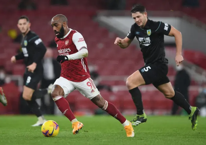 Framed Print : Arsenal's Lacazette Clashes with Burnley's Tarkowski in Premier League Showdown