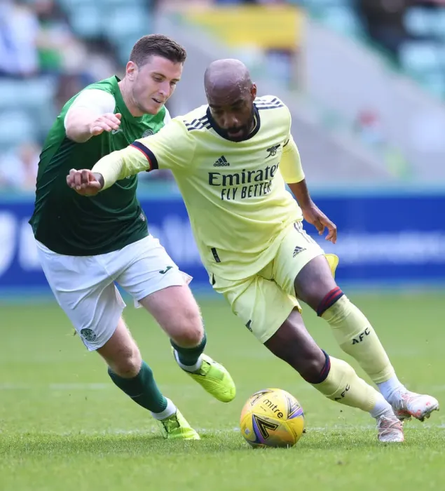 Framed Print : Arsenal's Lacazette Clashes with Hanlon in Hibernian Pre-Season Encounter