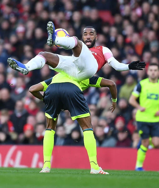 Arsenal's Lacazette Clashes with Huddersfield's Jorgensen in Premier League Showdown