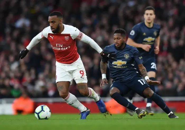 Framed Print : Arsenal's Lacazette Clashes with Manchester United's Fred in Premier League Showdown