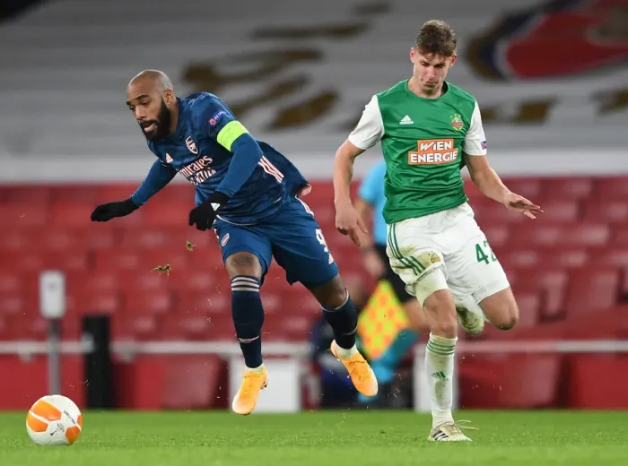 Framed Print : Arsenal's Lacazette Clashes with Rapid Wien's Schuster in Europa League Showdown