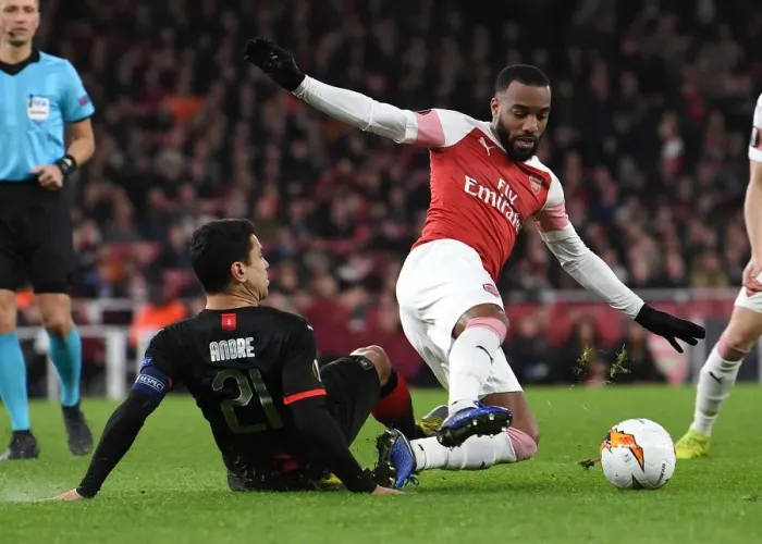 Framed Print : Arsenal's Lacazette Clashes with Rennais Andre in Europa League Showdown Framed Print : Arsenal's Lacazette Clashes with Rennais Andre in Europa League Showdown