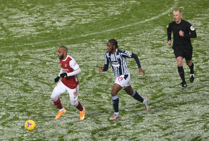 Framed Print : Arsenal's Lacazette Clashes with West Brom's Sawyers in Premier League Showdown