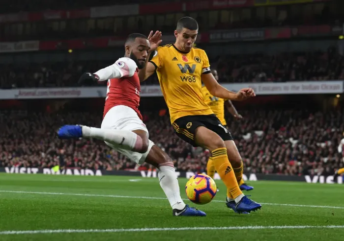 Framed Print : Arsenal's Lacazette Clashes with Wolverhampton's Coady in Premier League Showdown