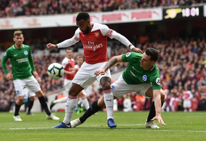 Framed Print : Arsenal's Lacazette Faces Off Against Brighton's Dunk in Intense Premier League Clash