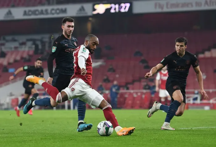Framed Print : Arsenal's Lacazette Faces Off Against Manchester City's Laporte and Dias in Carabao Cup Quarterfinal Showdown Framed Print : Arsenal's Lacazette Faces Off Against Manchester City's Laporte and Dias in Carabao Cup Quarterfinal Showdown