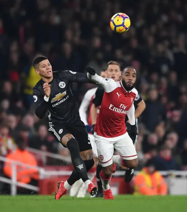 Framed Print : Arsenal's Lacazette Faces Off Against Manchester United's Rojo in Intense Premier League Clash Framed Print : Arsenal's Lacazette Faces Off Against Manchester United's Rojo in Intense Premier League Clash