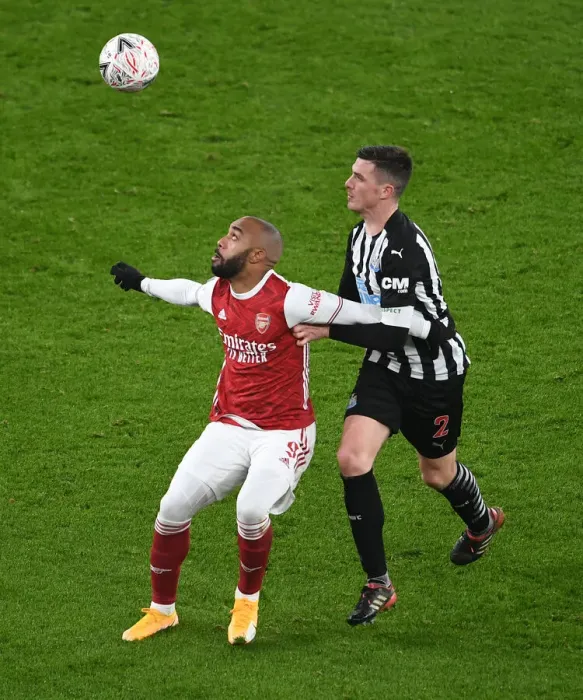 Framed Print : Arsenal's Lacazette Faces Off Against Newcastle's Clark in FA Cup Clash Framed Print : Arsenal's Lacazette Faces Off Against Newcastle's Clark in FA Cup Clash