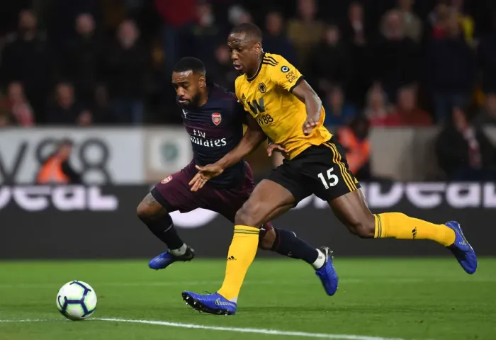 Framed Print : Arsenal's Lacazette Faces Off Against Wolves Boly in Premier League Clash (2018-19)