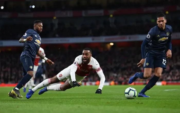 Framed Print : Arsenal's Lacazette Fouled by Fred in Intense Arsenal v Manchester United Clash (2018-19)