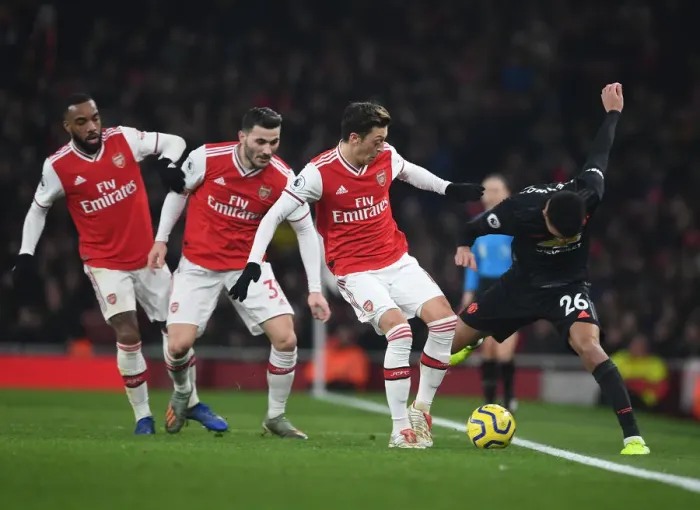 Framed Print : Arsenal's Lacazette, Kolasinac, and Ozil Pressure Greenwood in Arsenal v Manchester United (2019-20) Framed Print : Arsenal's Lacazette, Kolasinac, and Ozil Pressure Greenwood in Arsenal v Manchester United (2019-20)