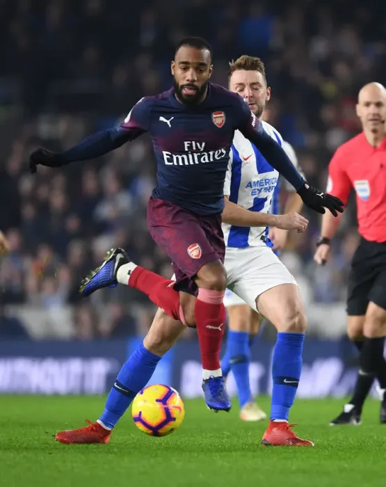 Framed Print : Arsenal's Lacazette Outmaneuvers Brighton's Stephens in Premier League Clash