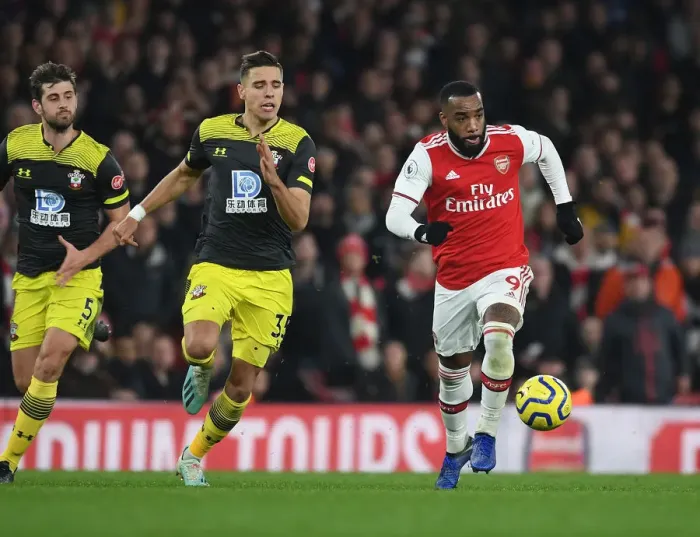 Framed Print : Arsenal's Lacazette Outmaneuvers Southampton's Bednarek in Premier League Clash