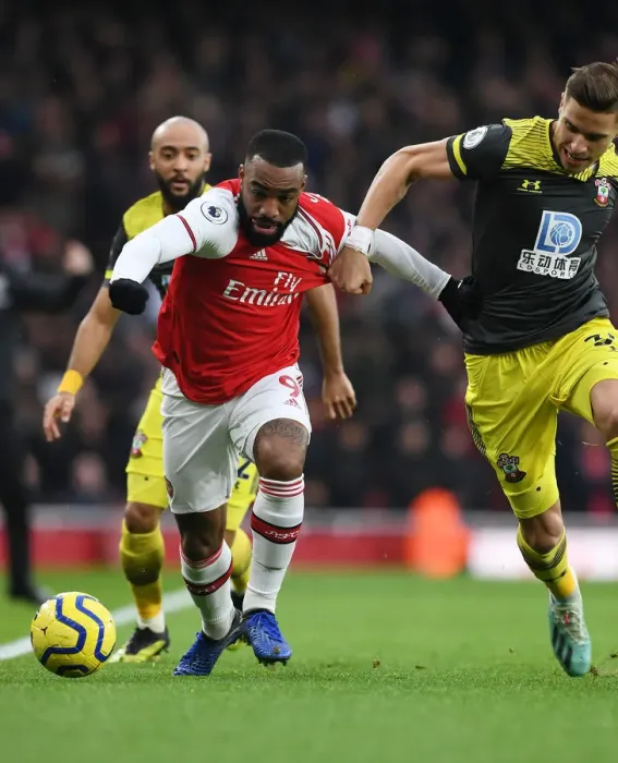 Framed Print : Arsenal's Lacazette Outwits Southampton's Bednarek: A Premier League Tactical Battle at Emirates Stadium