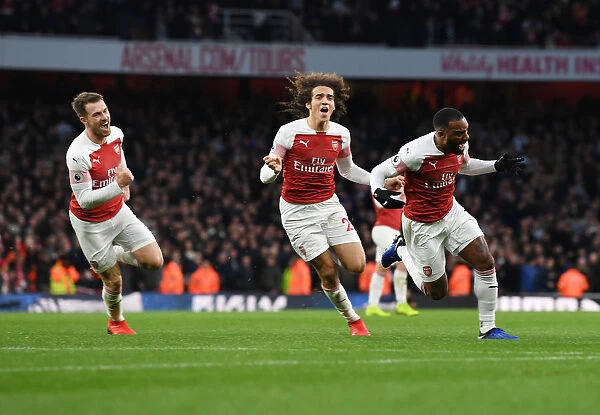 Arsenal's Lacazette, Ramsey, and Guendouzi Celebrate Goals Against Tottenham in 2018-19 Premier League