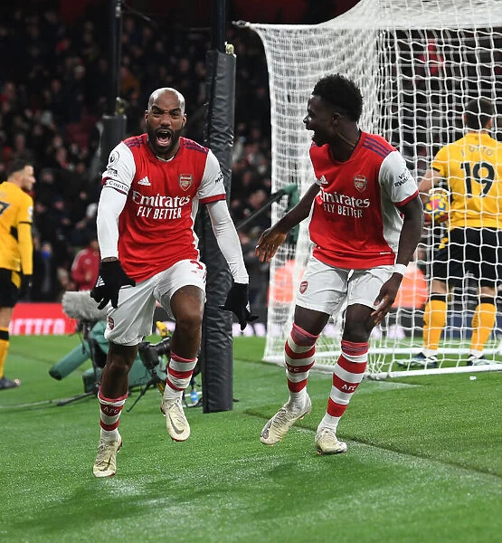 Arsenal's Lacazette and Saka Celebrate Goals Against Wolverhampton Wanderers in Premier League 2021-22