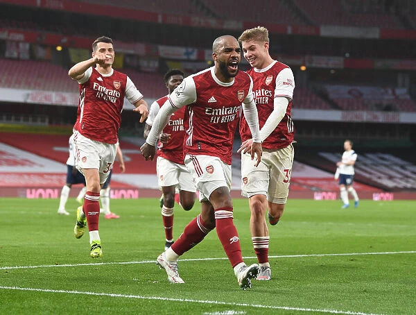 Arsenal's Lacazette, Xhaka, and Smith Rowe Celebrate Goals Against Tottenham in Empty Emirates Stadium