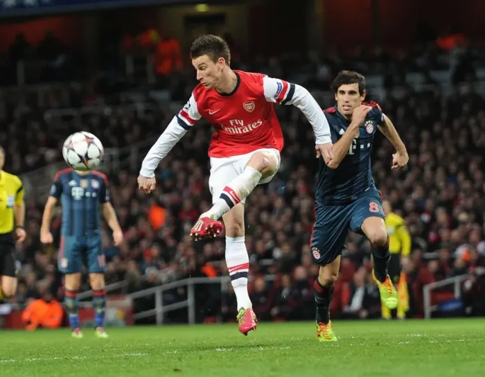 Framed Print : Arsenal's Laurent Koscielny Faces Off Against Bayern Munchen's Javi Martinez in Intense UCL Clash